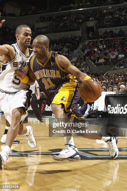 Jamaal Tinsley of the Indiana Pacers drives against Tony Parker of the San Antonio Spurs at the SBC Center January 6, 2005 in San Antonio, Texas....