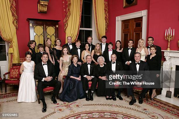 President George W. Bush, first lady Laura Bush, former first lady Barbara Bush and former President George H.W. Bush sit surrounded by family in the...