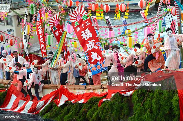 Fishermen and boys dressed and make-up as women dance on a decorated boat during annual Ose Festival at Suruga Bay on April 4, 2016 in Numazu,...