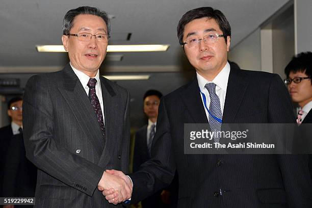 Chinese diplomat Wu Dawei and his counterpart Kimihiro Ishikane shake hands prior to their meeting at the Foreign Ministry on April 5, 2016 in Tokyo,...