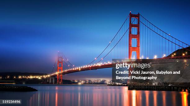 blue morning reflections of the golden gate bridge from fort baker - golden gate bridge stock pictures, royalty-free photos & images