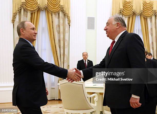 Russian President Vladimir Putin greets French Senate President Gerard Larcher during their meeting in the Kremlin on April 5, 2016 in Moscow,...