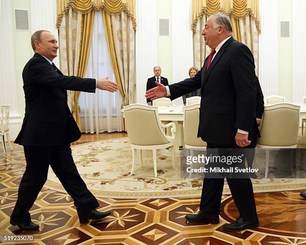 Russian President Vladimir Putin greets French Senate President Gerard Larcher during their meeting in the Kremlin on April 5, 2016 in Moscow,...