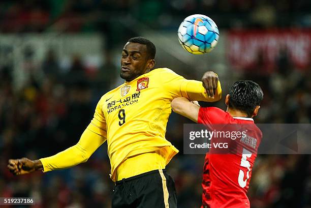 Jackson Martinez of Guangzhou Evergrande and Tomoaki Makino of Urawa Red Diamonds compete for the ball during the AFC Champions League Group H match...