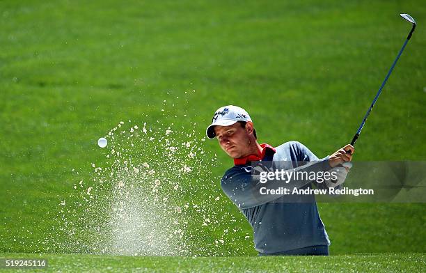 Emiliano Grillo of Argentina plays a shot from a bunker on the 16th hole during a practice round prior to the start of the 2016 Masters Tournament at...