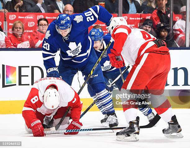 Justin Abdelkader covers the puck with help from Alexei Marchenko of the Detroit Red Wings against Frank Corrado of the Toronto Maple Leafs during...