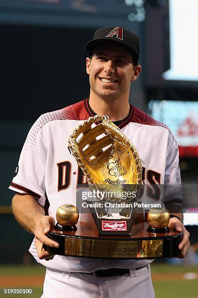 Paul Goldschmidt of the Arizona Diamondbacks poses with the Rawlings Gold Glove Award before the MLB opening day game against the Colorado Rockies at...