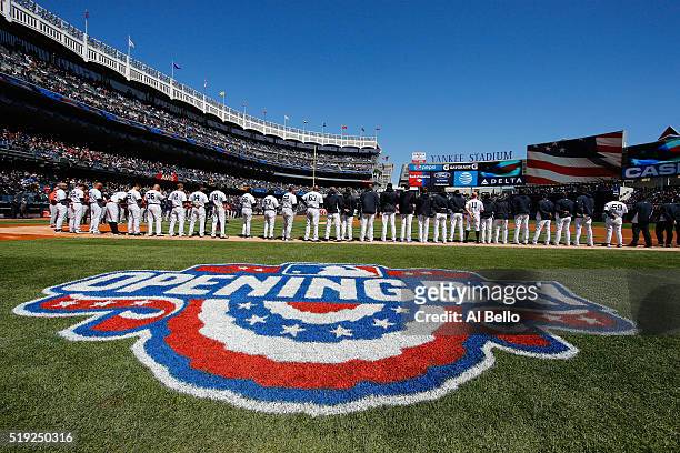 The New York Yankees stand for the National Anthem against the Houston Astros during Opening Day at Yankee Stadium on April 5, 2016 in New York City.