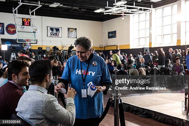 Volunteer gives out tickets before Democratic presidential candidate Hillary Clinton hosts a Women for Hillary Town Hall meeting with New York City...