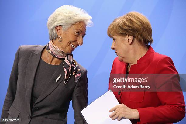 Christine Lagarde, director of the International Monetary Fund , and German Chancellor Angela Merkel attend a press conference in the German federal...