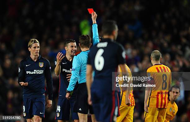 Fernando Torres of Atletico Madrid is shown a red card by referee Felix Brych and is sent off during the UEFA Champions League quarter final first...