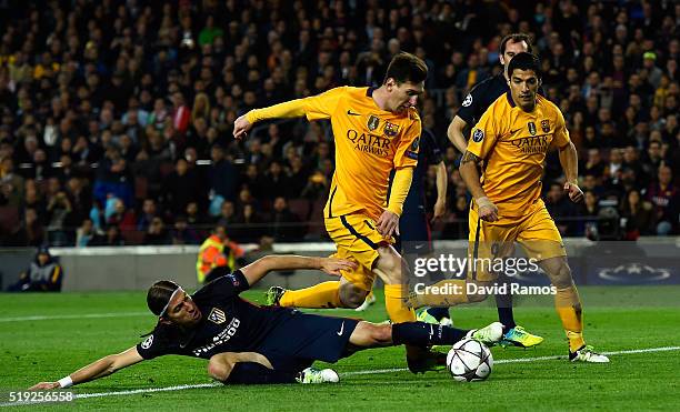 Lionel Messi of Barcelona is tackled by Filipe Luis of Atletico Madrid during the UEFA Champions League quarter final first leg match between FC...