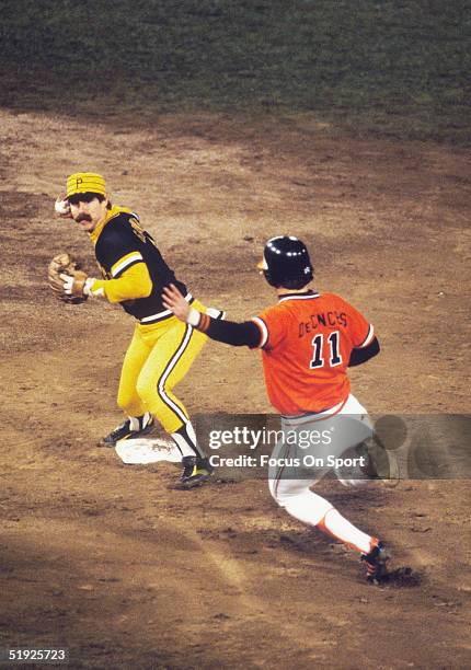 Baltimore Orioles' Doug DeCinces slides into second as Pittsburgh Pirates' second baseman Phil Garner forces an out and prepares to throw to first...