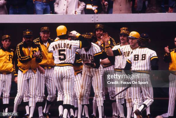 Pittsburgh Pirates' infielder Bill Madlock gets a hero's welcome from his teammates as he walks back to the dugout during the World Series against...