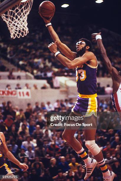 Los Angeles Lakers' Kareem Abdul Jabbar jumps to make a hook shot against the New York Nets at Madison Square Garden in December, 1979 in New York,...
