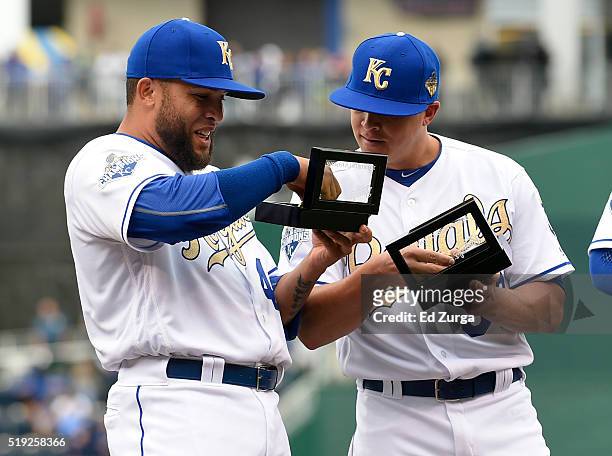 Kelvin Herrera and Kris Medlen of the Kansas City Royals look at their World Series Championship ring during a ceremony prior to a game against the...