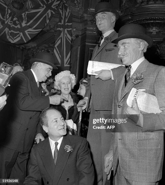 Picture taken 19 December 1956 shows French writer Pierre Daninos posing next to the wax statue of one of his characters Major Thompson at the Musee...