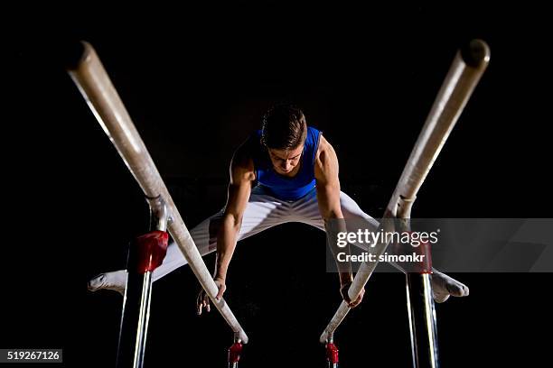 male gymnast in sports hall - parallel bars gymnastics equipment 個照片及圖片檔