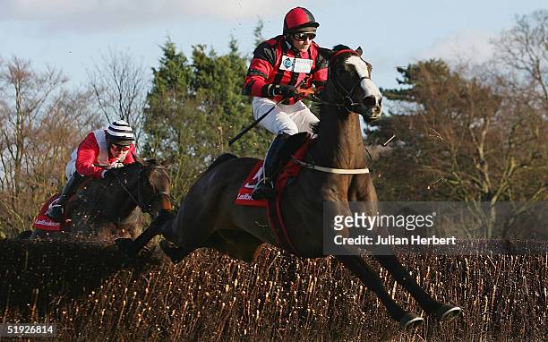 Jamie Moore and Oneway clear the 2ND last fence before landing The Ladbrokescasino.com Handicap Chase Race run at Sandown Racecourse on January 8,...