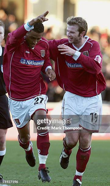 Lee Williamson of Northampton celebrates his goal with team mate Martin Smith during the FA Cup Third Round match between Northampton Town and...