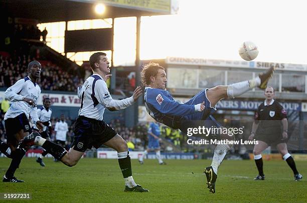 Mark Hughes of Oldham tries to beat Joey Barton of Manchester during the FA Cup third round match between Oldham Athletic and Manchester City at...