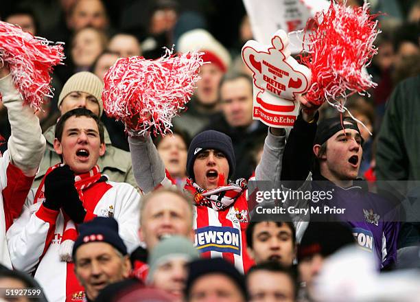 Exeter City fans look on in jubilant mood during the FA Cup third round match between Manchester United and Exeter City at Old Trafford on January 8,...