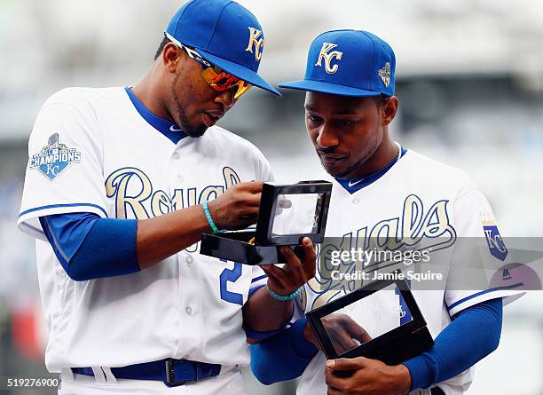 Alcides Escobar and Jarrod Dyson of the Kansas City Royals inspect their 2015 World Series Championship rings during a ring ceremony prior to the...