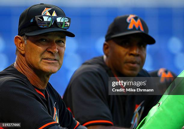 Manager Don Mattingly and hitting coach Barry Bonds of the Miami Marlins talk during 2016 Opening Day against the Detroit Tigers at Marlins Park on...