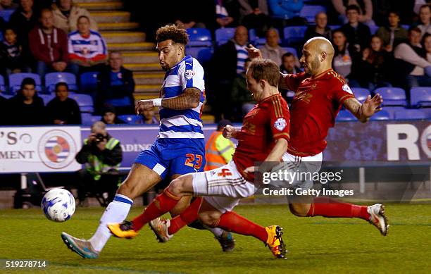 Danny Williams of Reading gets in a shot on goal as David Vaughan and Kelvin Wilson of Nottingham Forest slide in to try to block on April 5, 2016 in...