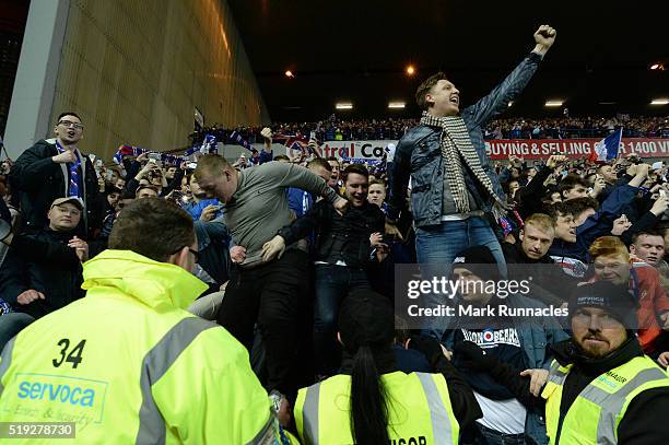 Rangers fans celebrate as Rangers beat Dumbarton 1-0 to clinch the Scottish Championship title during the match between Glasgow Rangers FC and...