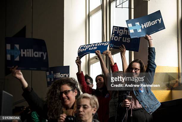 Attendees hold signs as Democratic presidential candidate Hillary Clinton hosts a Women for Hillary Town Hall meeting with New York City first lady...