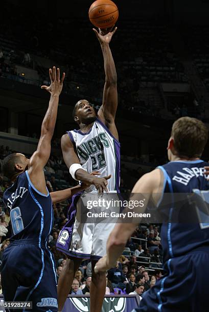 Michael Redd of the Milwaukee Bucks shoots between Howard Eisley and Matt Harpring of the Utah Jazz during the NBA game at the Bradley Center on...