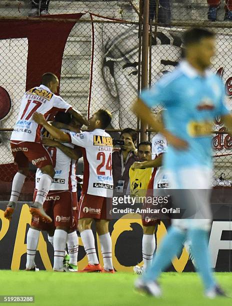 Ramon Abila of Huracan celebrates with teammates after scoring the second goal of his team during a match between Huracan and Sporting Cristal as...