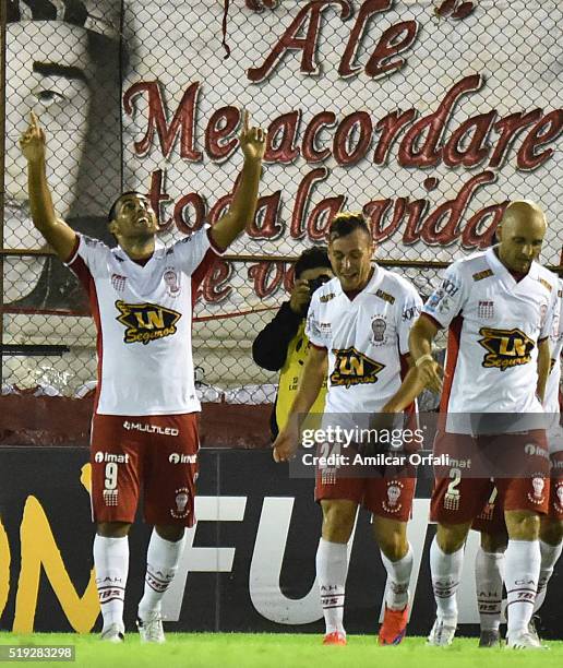 Ramon Abila of Huracan celebrates with teammates after scoring the second goal of his team during a match between Huracan and Sporting Cristal as...