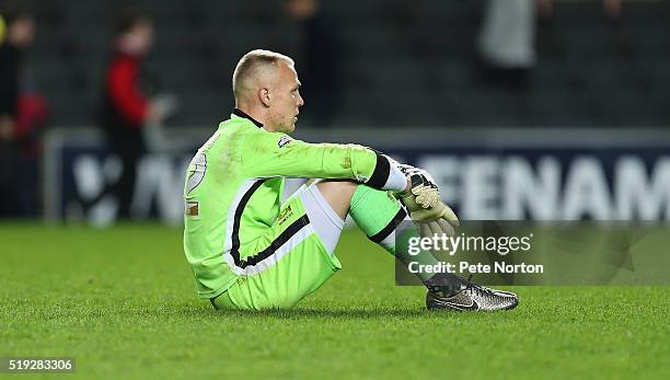 Cody Cropper of Milton Keynes Dons sits dejected after defeat at the final whistle during the Sky Bet Championship match between Milton Keynes Dons...