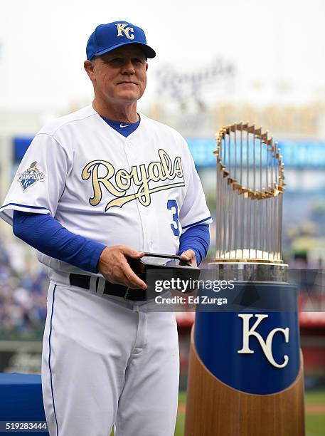 Ned Yost manger of the of the Kansas City Royals holds a box containing a World Series Championship ring as he waits to present it to a member of...
