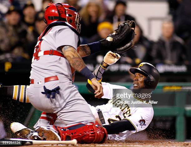 Andrew McCutchen of the Pittsburgh Pirates is tagged out at home by Yadier Molina of the St. Louis Cardinals in the third inning during the game at...