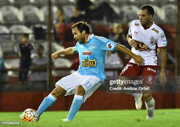 Renzo Revoredo of Sporting Cristal fights for the ball with Mariano Gonzalez of Huracan during a match between Huracan and Sporting Cristal as part...