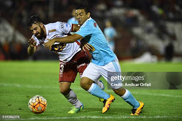 Jose San Roman of Huracan fights for the ball with Alfredo Ramua of Sporting Cristal during a match between Huracan and Sporting Cristal as part of...