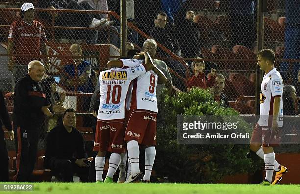 Alejandro Romero Gamarra of Huracan celebrates with teammates Daniel Montenegro and Ramon Abila after scoring the third goal of his team during a...