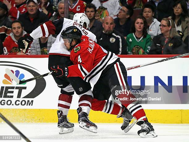 Niklas Hjalmarsson of the Chicago Blackhawks stops Anthony Duclair of the Arizona Coyotes from advancing the puck at the United Center on April 5,...