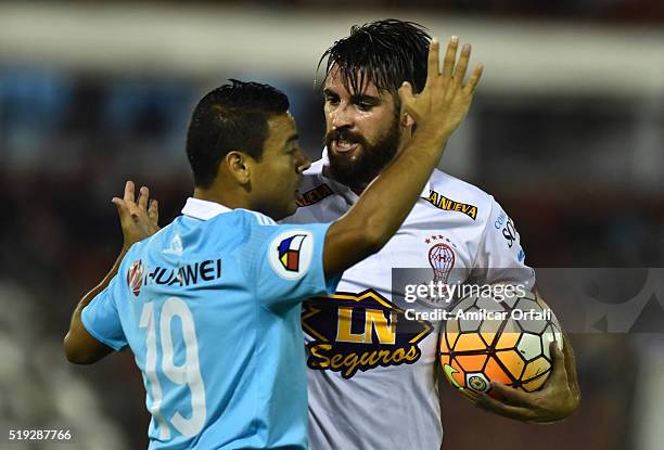 Jose San Roman of Huracan and Alfredo Ramua scuffle during a match between Huracan and Sporting Cristal as part of Group 4 of Copa Bridgestone...