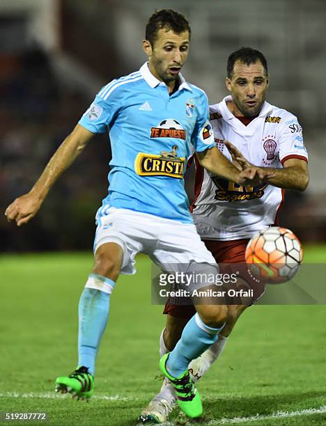 Horacio Calcaterra of Sporting Cristal fights for the ball with Mariano Gonzalez of Huracan during a match between Huracan and Sporting Cristal as...