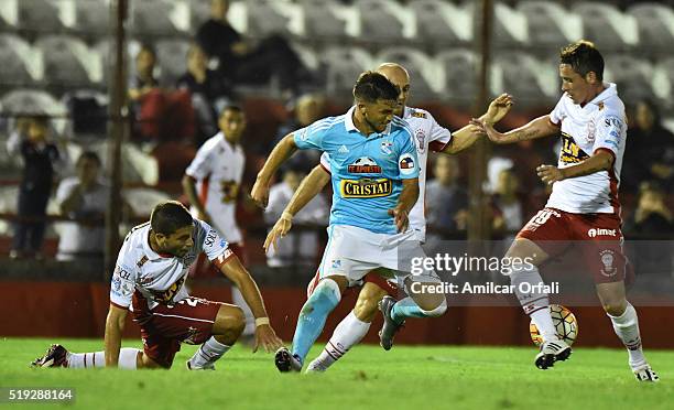 Gabriel Costa of Sporting Cristal fights for the ball with Hugo Nervo, Federico Mancinelli and Mauro Bogado of Huracan during a match between Huracan...