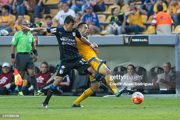 Juninho of Tigres fights for the ball with Edgar Benitez of Queretaro during the semifinals second leg match between Tigres UANL and Queretaro as...