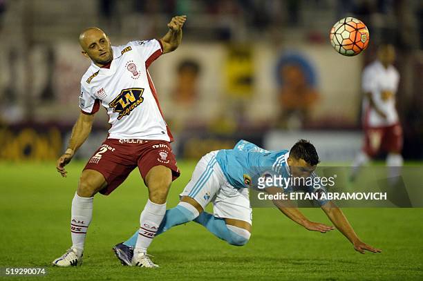 Perus Sporting Cristal player defender midfielder Gabriel Costa vies for the ball against Argentinas Huracan player defender Federico Mancinelli...