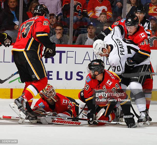 Deryk Engelland of the Calgary Flames collides with goaltender Joni Ortio against the Los Angeles King at Scotiabank Saddledome on April 5, 2016 in...