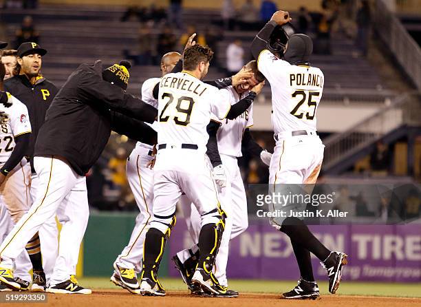 Jordy Mercer of the Pittsburgh Pirates celebrates a walk off RBI single in the eleventh inning with teammates during the game against the St. Louis...