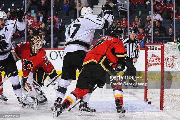 Milan Lucic of the Los Angeles Kings score against Joni Ortio of the Calgary Flames during an NHL game at Scotiabank Saddledome on April 5, 2016 in...