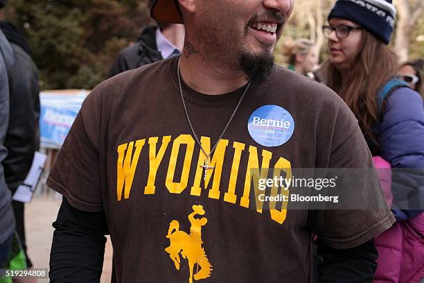 An attendee wears a Wyoming T-shirt and a campaign sticker for Senator Bernie Sanders, an independent from Vermont and 2016 Democratic presidential...